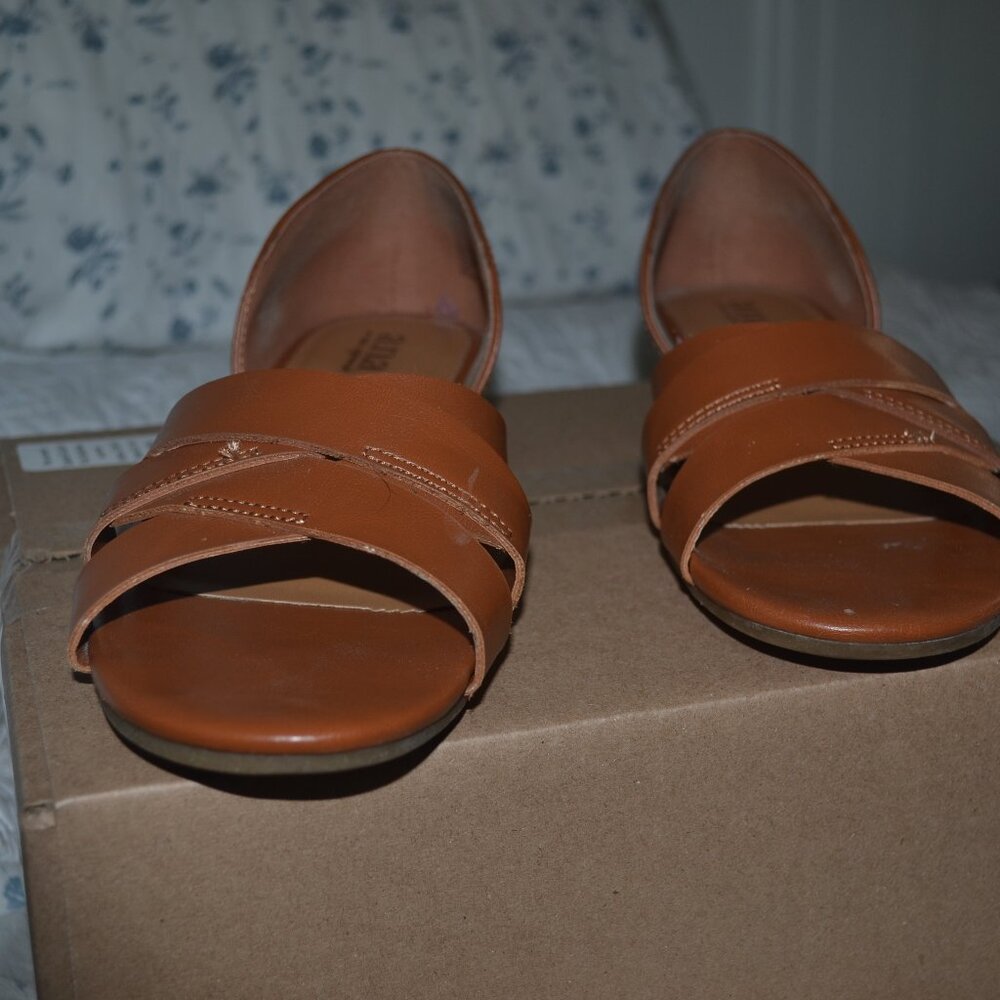 Pre-owned pair of A.N.A. cognac color flat sandals. Criss-cross straps, size 8 m
